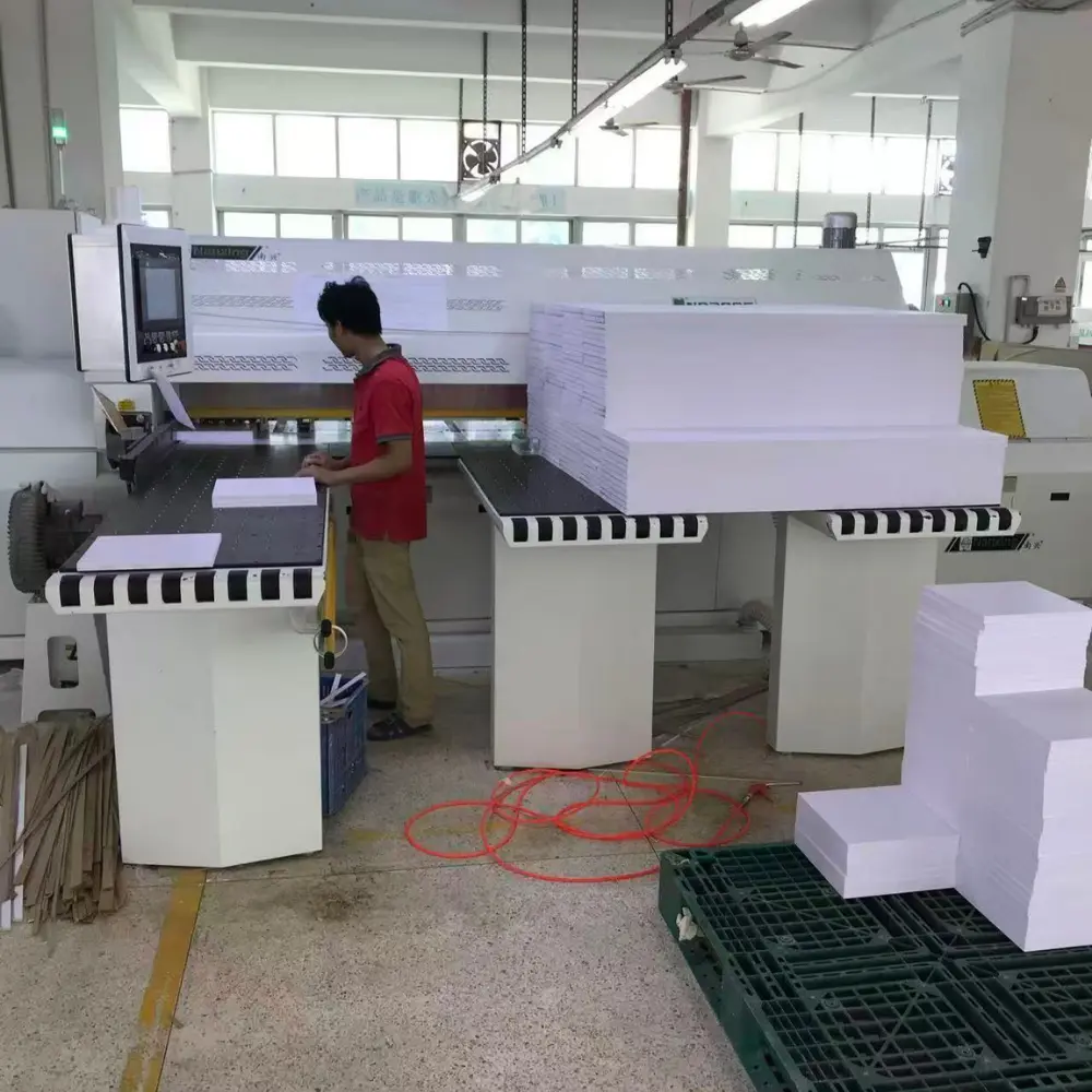 Skilled worker operating a precision panel saw to cut raw materials at a Custom Display Manufacturer workshop