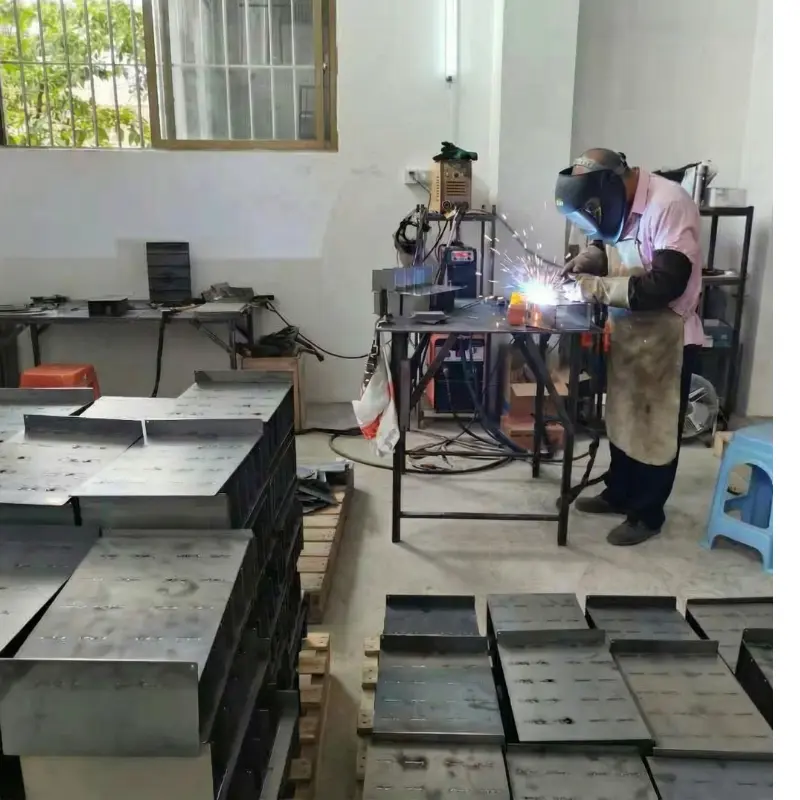 Professional metal welding and fabrication process for custom display stand frames at our factory.