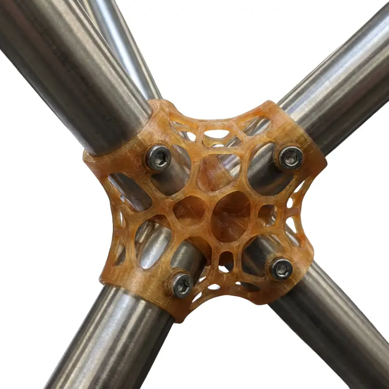 Close-up of translucent 3D printed generative design joint connecting metal tubes